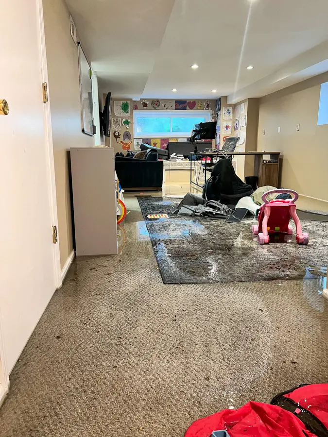 Hopkinton water damage cleanup in a finished basement where water spread across the carpet and furniture.