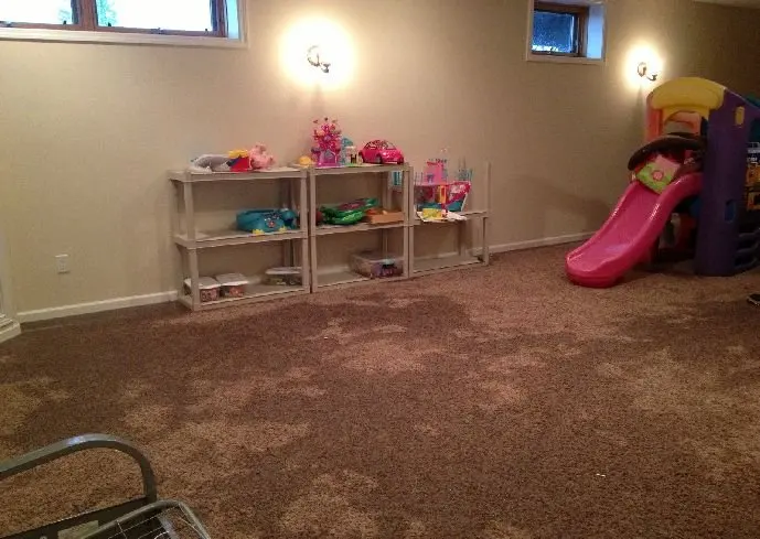 Finished Hooksett basement with soaked, stained carpet being prepared for extraction and structural drying by local experts